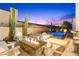 Inviting backyard with fire pit, pool, spa, and lounge chairs perfect for outdoor entertaining at 2710 Marchetti Pl, Henderson, NV 89044
