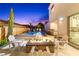 Backyard features a fire pit, pool, spa, outdoor kitchen, and lounge chairs, perfect for entertaining at 2710 Marchetti Pl, Henderson, NV 89044