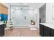 Modern bathroom boasting a spacious walk-in shower, wood-look tile floors, and updated vanity at 2710 Marchetti Pl, Henderson, NV 89044