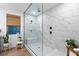 Elegant bathroom showcasing a frameless glass shower with marble-look tile and modern matte black fixtures at 2710 Marchetti Pl, Henderson, NV 89044