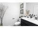 Stylish half bathroom featuring a modern vanity, artwork, and sleek fixtures at 2710 Marchetti Pl, Henderson, NV 89044