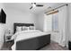 Modern bedroom featuring a gray upholstered bed, white walls, and a large window with natural light at 2710 Marchetti Pl, Henderson, NV 89044