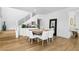 Bright dining area features modern decor, wood floors, and a view of the staircase with white banisters at 2710 Marchetti Pl, Henderson, NV 89044