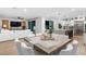 Open-concept dining area adjacent to the living room and kitchen with contemporary style and modern furnishings at 2710 Marchetti Pl, Henderson, NV 89044