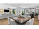 Bright, open-concept dining area with wood table, kitchen, and living room in a modern home at 2710 Marchetti Pl, Henderson, NV 89044