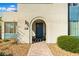 Welcoming front entrance with an arched entryway, stone pathway, and stylish door, creating a warm invitation at 2710 Marchetti Pl, Henderson, NV 89044