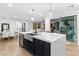 Spacious kitchen island with a stainless steel sink, modern fixtures, and an open view of living spaces at 2710 Marchetti Pl, Henderson, NV 89044