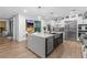 Modern kitchen with a large island, stainless steel appliances, white cabinetry, and access to the backyard at 2710 Marchetti Pl, Henderson, NV 89044
