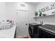 Modern laundry room with front load washer and dryer, sleek countertops, and ample storage at 2710 Marchetti Pl, Henderson, NV 89044