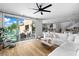 Inviting living room with a large sectional sofa, glass sliding doors, and outdoor views at 2710 Marchetti Pl, Henderson, NV 89044