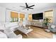 Comfortable living room featuring a sectional sofa, stylish decor, and window blinds at 2710 Marchetti Pl, Henderson, NV 89044