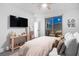 Modern main bedroom featuring a tv, ceiling fan and slider to rooftop deck at 2710 Marchetti Pl, Henderson, NV 89044