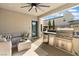 Covered patio featuring an outdoor kitchen, barbecue, bar, and seating area for entertaining at 2710 Marchetti Pl, Henderson, NV 89044