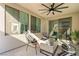 Cozy outdoor patio featuring comfortable seating, a stylish ceiling fan, and a relaxing ambiance at 2710 Marchetti Pl, Henderson, NV 89044