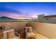 Scenic patio showcasing comfortable seating, lighting, and a stunning view of the city and mountains at 2710 Marchetti Pl, Henderson, NV 89044