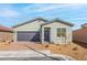 Charming single-story home with a gray facade, complemented by a two-car garage and neat landscaping at 2733 Avril Point St, Las Vegas, NV 89156