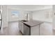 Open-concept kitchen island with sink and stainless dishwasher overlooks a spacious living area at 2733 Avril Point St, Las Vegas, NV 89156