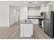 Modern kitchen boasts stainless steel appliances, white cabinets, a central island, and an open layout at 2733 Avril Point St, Las Vegas, NV 89156