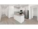 Bright kitchen with white cabinetry, stainless steel appliances, and a center island with a sink at 2733 Avril Point St, Las Vegas, NV 89156