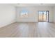 Spacious living room with hardwood floors, a sliding glass door, and ample natural light at 2733 Avril Point St, Las Vegas, NV 89156