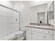 A minimalist bathroom featuring a glass shower, a toilet, and a modern vanity at 2739 Avril Point St, Las Vegas, NV 89156