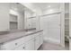 Bathroom with sleek glass shower, modern vanity, and storage shelves at 2739 Avril Point St, Las Vegas, NV 89156