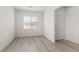 Bright bedroom with wood-look flooring, a window with blinds, and a white door at 2739 Avril Point St, Las Vegas, NV 89156