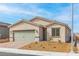 Inviting single-story home with a brick driveway, two-car garage, and desert landscaping against a blue sky at 2739 Avril Point St, Las Vegas, NV 89156