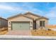 Charming single-story home featuring a two-car garage and low-maintenance desert landscaping in front at 2739 Avril Point St, Las Vegas, NV 89156