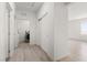 Hallway featuring wood-look floors, access to the laundry area, and ample closet space at 2739 Avril Point St, Las Vegas, NV 89156