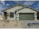 Charming single-story home featuring a two-car garage and desert landscaping at 3212 Walker River St, North Las Vegas, NV 89032