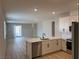 Modern kitchen with white cabinets, stainless steel appliances, and an open concept layout at 3212 Walker River St, North Las Vegas, NV 89032
