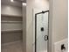 Modern shower with marble tile and a sleek black frame at 3212 Walker River St, North Las Vegas, NV 89032