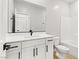 Bathroom featuring modern fixtures, white cabinets, and a shower-tub combination at 3240 Lahontan St, North Las Vegas, NV 89032
