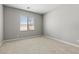 Cozy bedroom with neutral carpet, a window, and ample natural light at 3240 Lahontan St, North Las Vegas, NV 89032