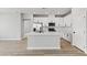 Modern kitchen featuring stainless steel appliances, white cabinets, and a large island at 3240 Lahontan St, North Las Vegas, NV 89032