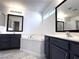 Bright bathroom with dual sinks, soaking tub, and stylish dark cabinets at 3311 Fico Ave, Las Vegas, NV 89141