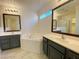 Bathroom with dual sinks, tub, and stylish mirrors above each vanity at 3311 Fico Ave, Las Vegas, NV 89141