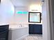 Bathroom featuring a soaking tub, vanity with dark cabinets, and tiled floors at 3311 Fico Ave, Las Vegas, NV 89141