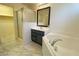 Bathroom showcasing a shower, soaking tub, gray vanity, and elegant tile flooring at 3311 Fico Ave, Las Vegas, NV 89141