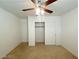 Bedroom with a closet, ceiling fan, neutral walls, and carpet flooring at 3311 Fico Ave, Las Vegas, NV 89141