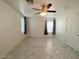 Bright bedroom featuring a ceiling fan, neutral walls, and tile flooring at 3311 Fico Ave, Las Vegas, NV 89141
