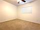 Cozy bedroom with neutral carpet, ceiling fan, and a window for natural light at 3311 Fico Ave, Las Vegas, NV 89141