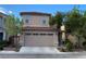 Two-story house with tile roof and a wide two-car garage door at 3311 Fico Ave, Las Vegas, NV 89141