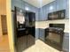 Kitchen showcasing modern black appliances and painted cabinets at 3311 Fico Ave, Las Vegas, NV 89141