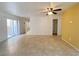 Tiled floor, ceiling fan, and sliding glass doors in living area at 3311 Fico Ave, Las Vegas, NV 89141