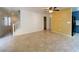 Open living space with tiled flooring, stairs, and view into the kitchen at 3311 Fico Ave, Las Vegas, NV 89141