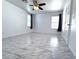 Bright living room featuring tile floors, ceiling fan and bright light at 3311 Fico Ave, Las Vegas, NV 89141