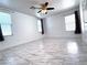 Spacious living room featuring tile floors, ceiling fan, and windows with blinds at 3311 Fico Ave, Las Vegas, NV 89141