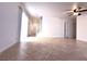 Bright living area featuring stairway, tile flooring, and door for closet space at 3311 Fico Ave, Las Vegas, NV 89141